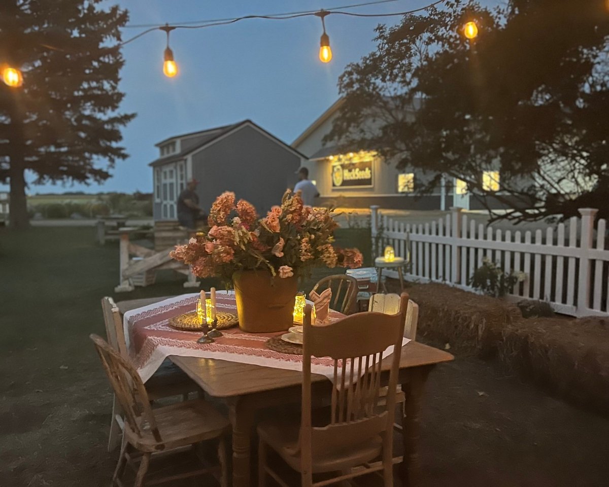 An intimate private event setting at dusk on the farm.